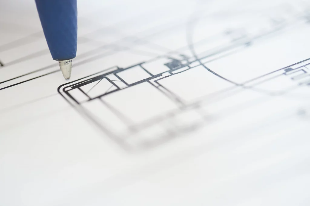 Pen on a technical drawing of a handling system.